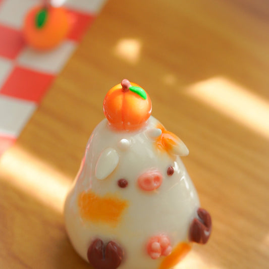 A small white clay cow figurine balancing a peach on its head., Set on a wooden surface with warm sunlight and shadows.