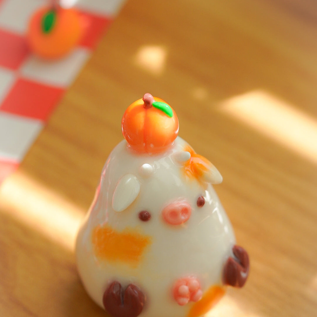 A small white clay cow figurine balancing a peach on its head., Set on a wooden surface with warm sunlight and shadows.